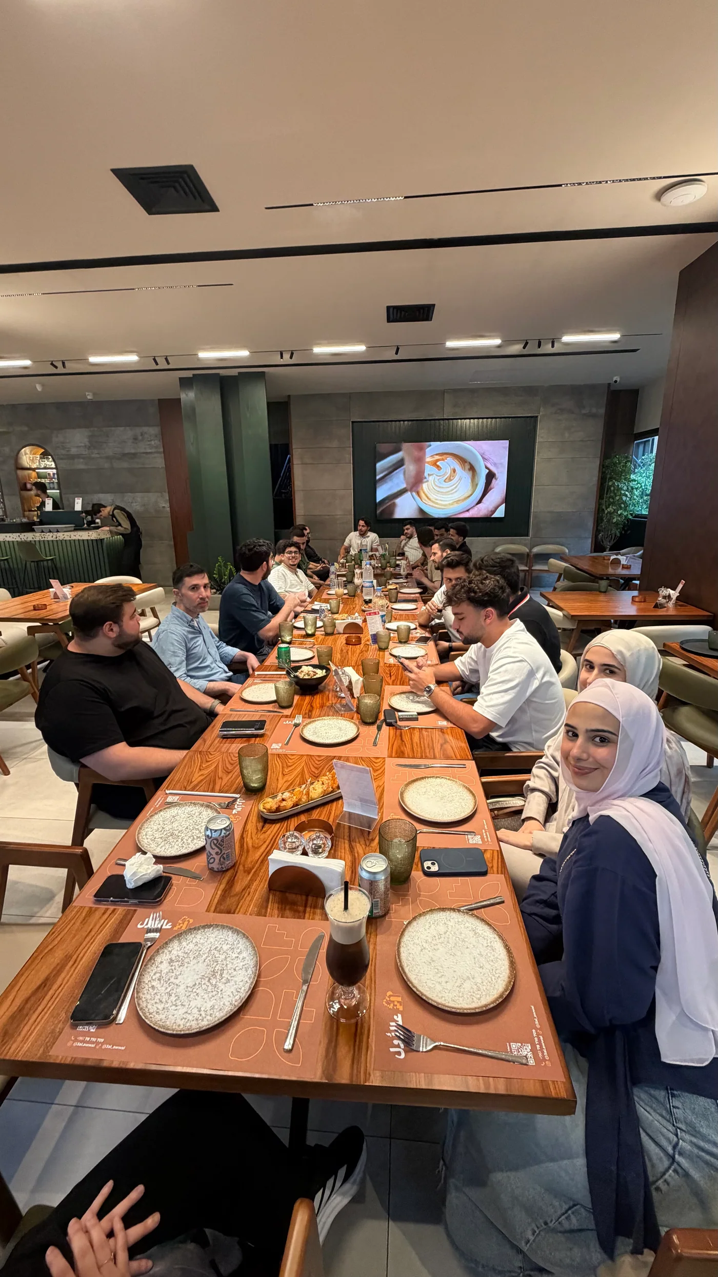 Lebanese in AI members seated around a long table during the July Beirut meetup